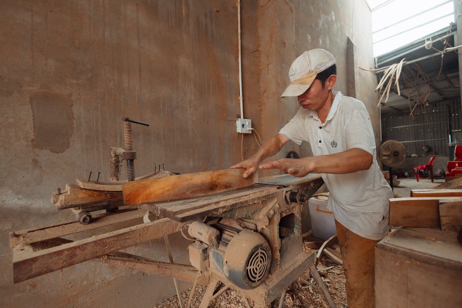 Master carpenter working on handmade furniture in a woodshop